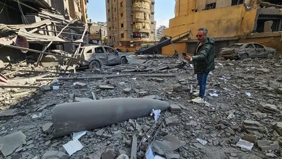 People inspecting damage at a building after an Israeli airstrike in Beirut during the escalating US-Iran conflict in the Middle East.